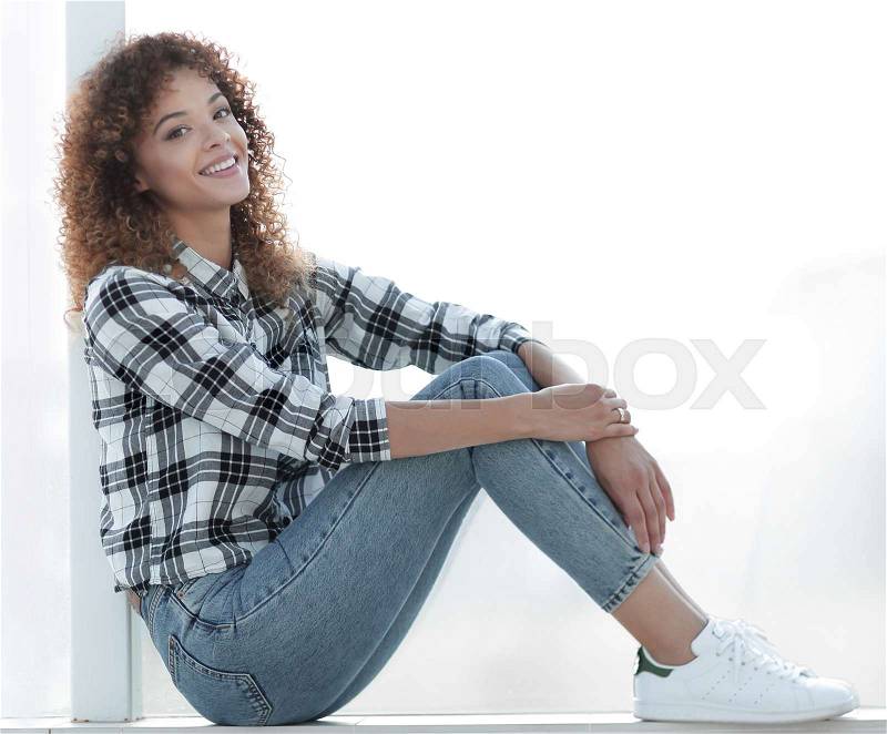 Portrait of a cute young woman in a plaid shirt and jeans. Photo with copy space, stock photo