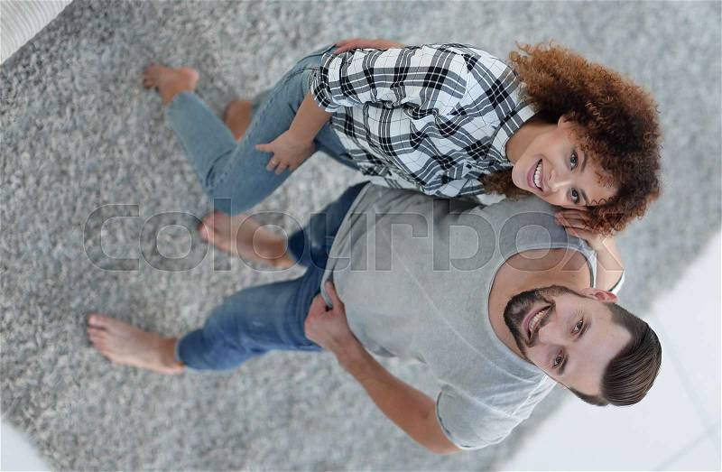 View from above happy young couple give each other five in new living room, stock photo
