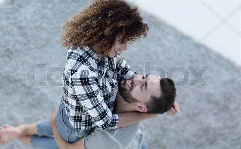 View from above happy young couple exulting in new apartment, stock photo
