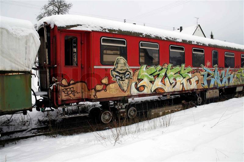 Outdoor shot of a old tagged railway car in Southern Germany at winter time, stock photo