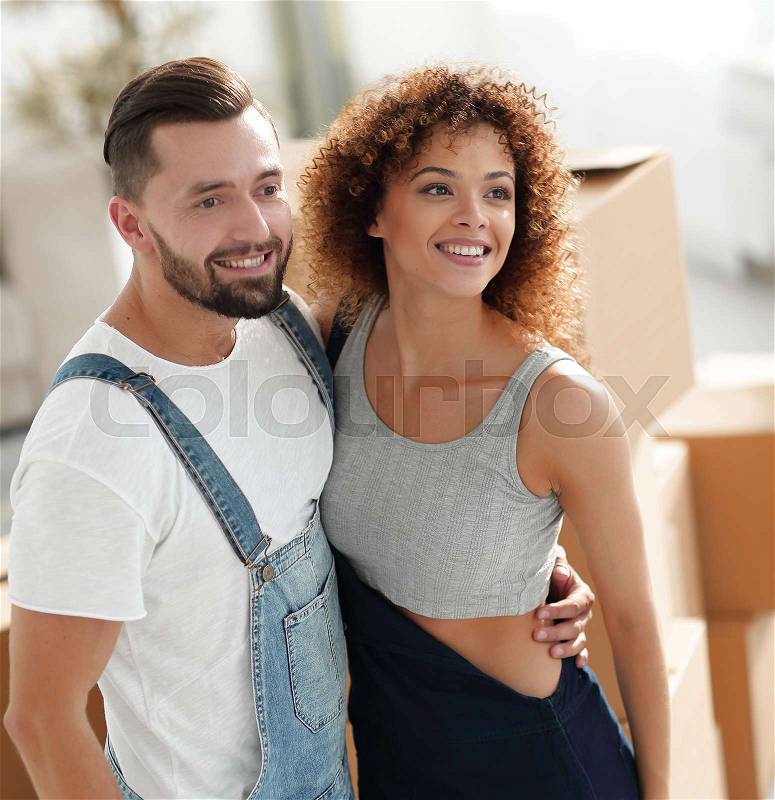 Happy couple in a new apartment. Planning the future, preparing housewarming, stock photo
