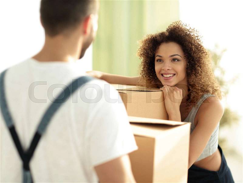 Young wife when moving to a new house. Concept of family happiness, stock photo