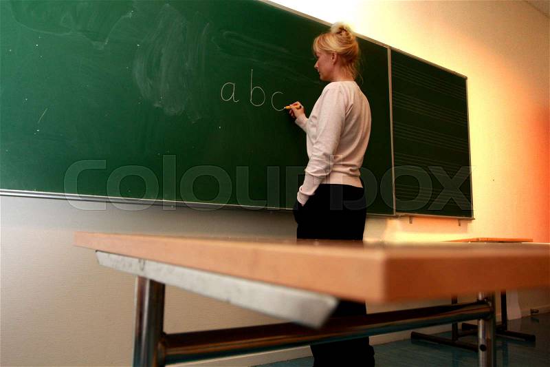 Teacher by the Blackboard, stock photo