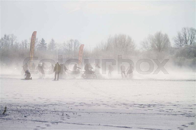 Ski-joring people on a frozen lake, stock photo