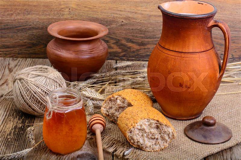 Healthy rustic breakfast. Milk in jug and bread on wooden table. Studio Photo, stock photo