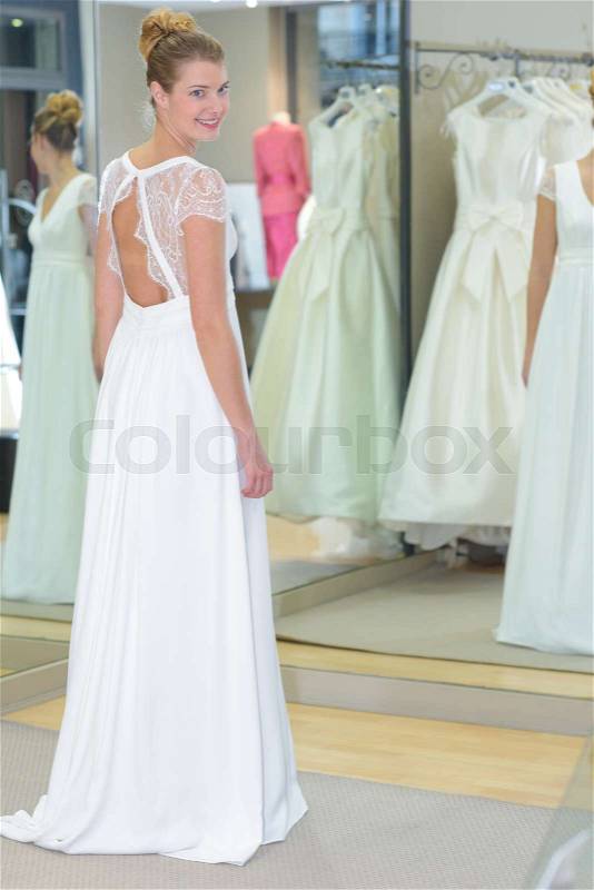 Women choosing wedding dress in shop, stock photo