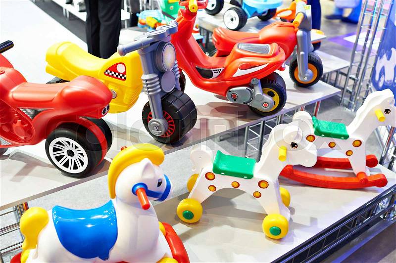 Plastic horses and bicycles in a toy store, stock photo