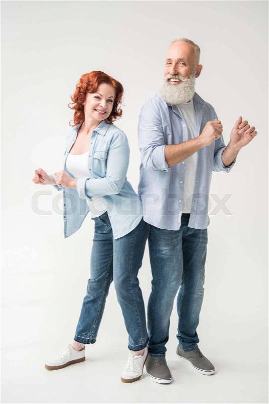 Smiling mature couple dancing isolated on white, stock photo