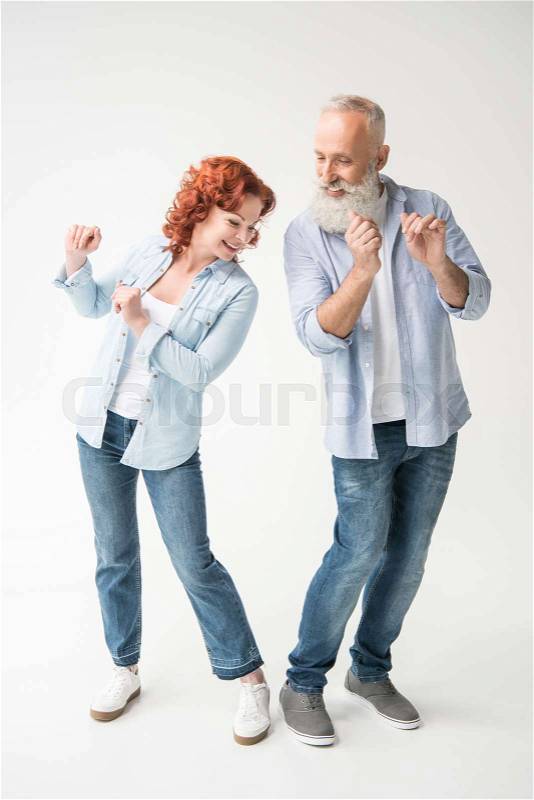 Happy mature couple dancing isolated on white, stock photo