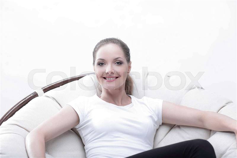 Woman resting in a circular chair with rattan.photo with copy space, stock photo