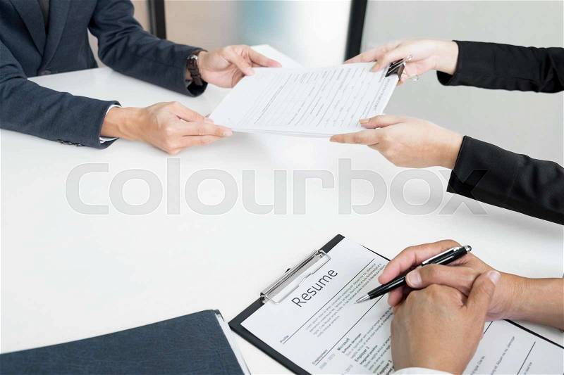 Hands of man giving application portfolio to HR man in office for interview, stock photo