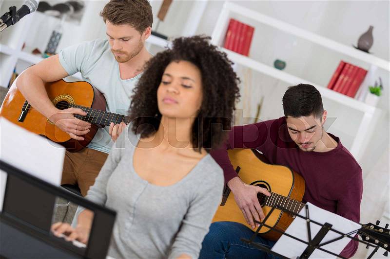Home band learning new song together, stock photo