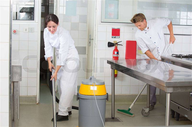 Kitchen aids are cleaning the restaurant kitchen, stock photo