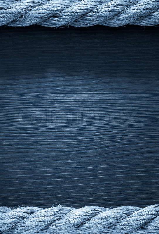 Ship rope on wooden background, stock photo