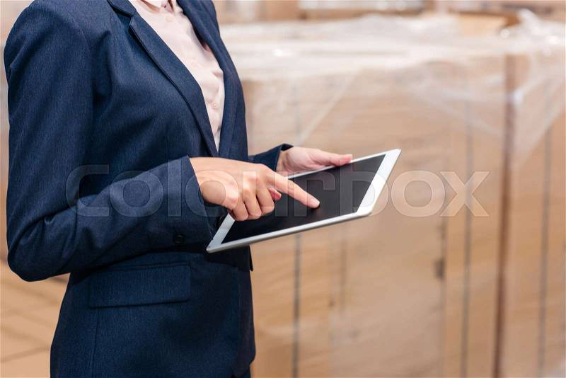 Cropped shot of businesswoman pointing at tablet, stock photo