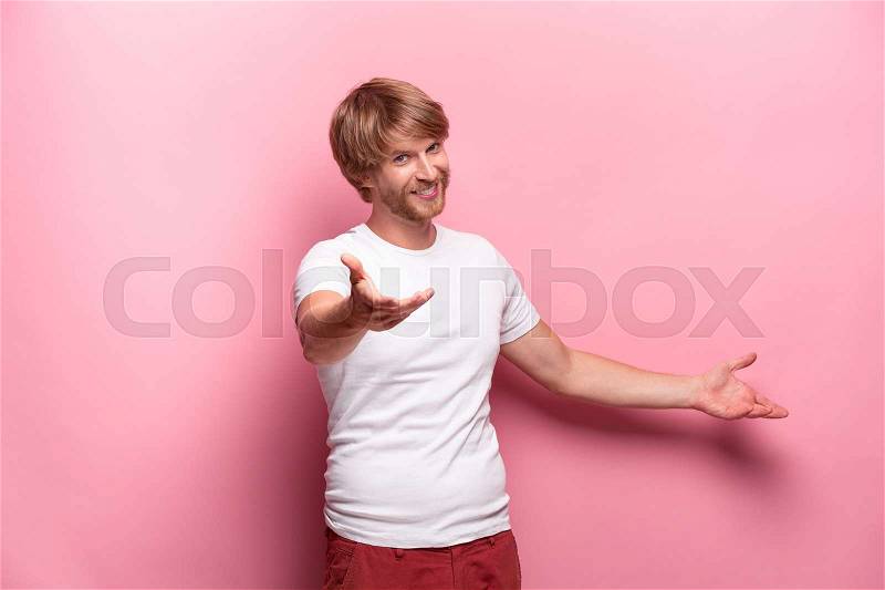 Portrait of young man with happy facial expression at studio, stock photo