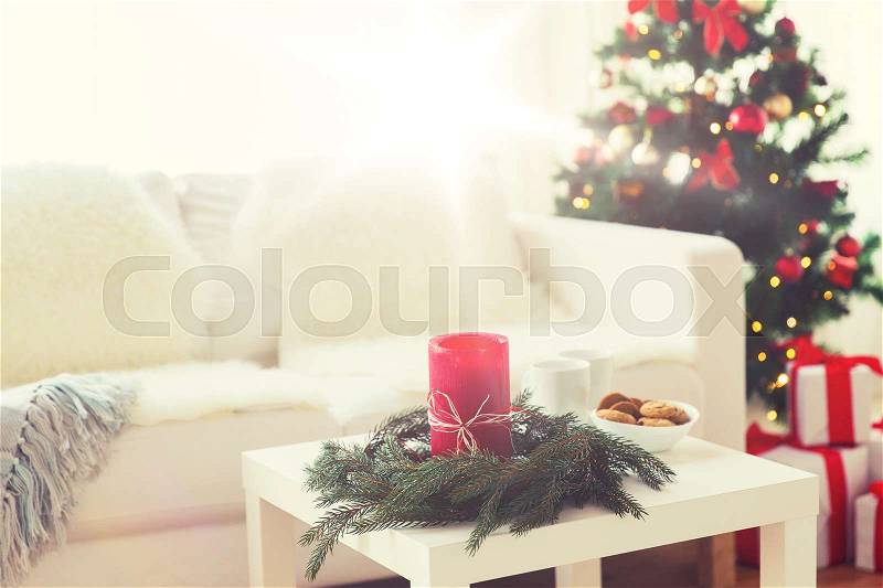 Holidays, winter, celebration and still life concept - sofa, table and christmas tree with gifts at home, stock photo