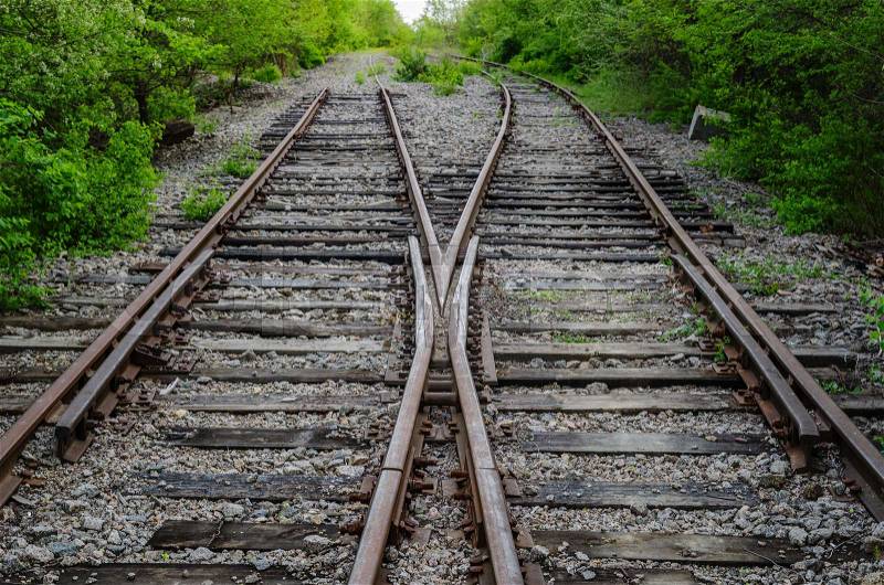 Crossing of two old railroad in wood, stock photo