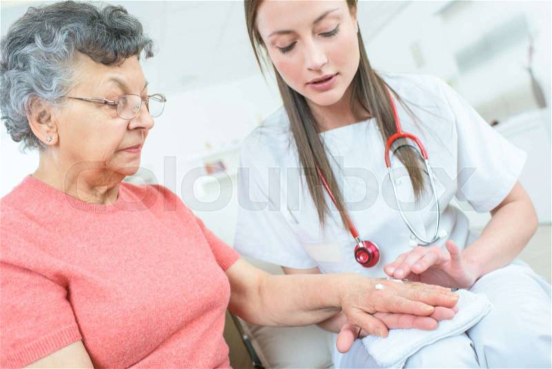 Young doctor being close to patient, stock photo