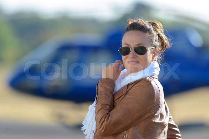 Pretty pilot woman on helicopter, stock photo