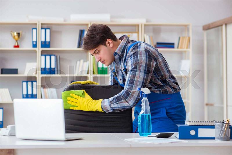 Male cleaner working in the office, stock photo