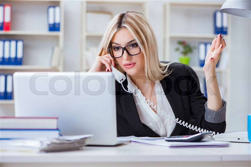 Busineswoman frustrated working in the office, stock photo