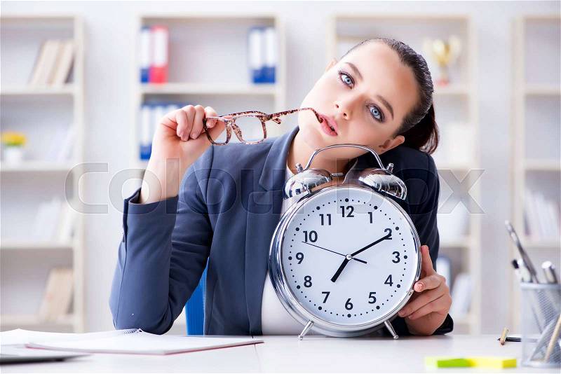 Businesswoman in time management concept, stock photo