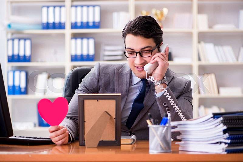 Businessman feeling love and loved in the office, stock photo