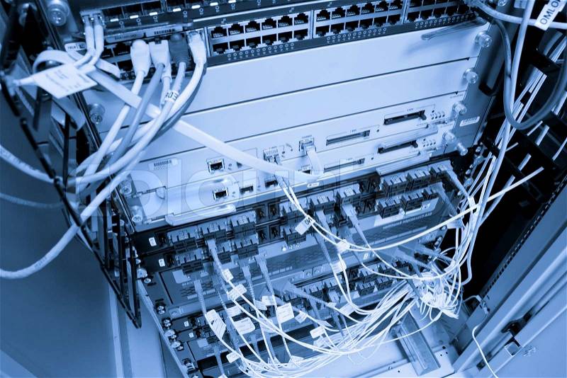 Cables connected to servers in a datacenter, stock photo