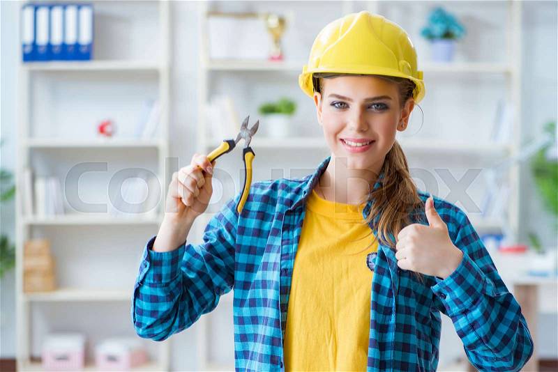 Woman in workshop with pliers, stock photo