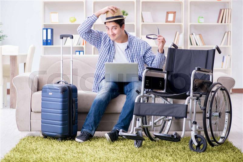 Disabled man booking travel online using laptop computer, stock photo