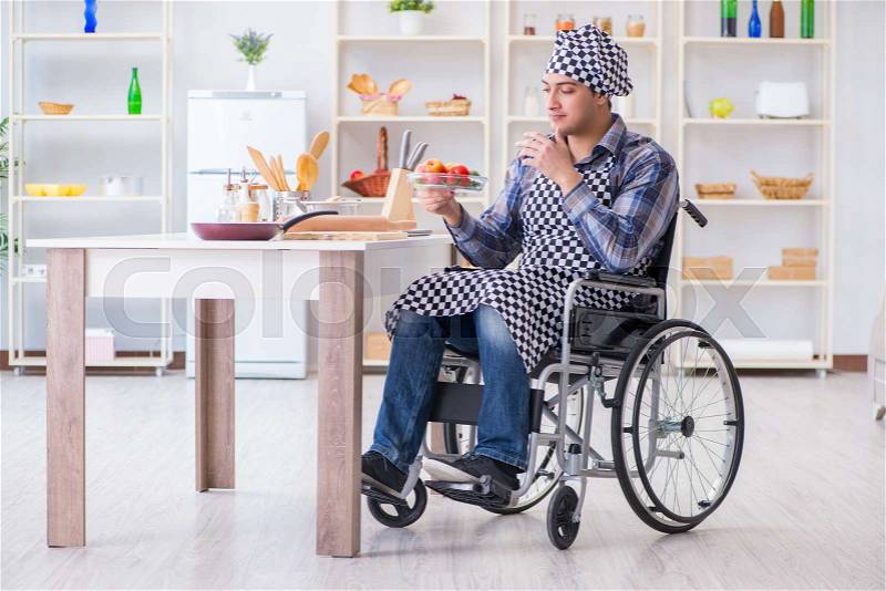 Young disabled husband preparing food salad, stock photo