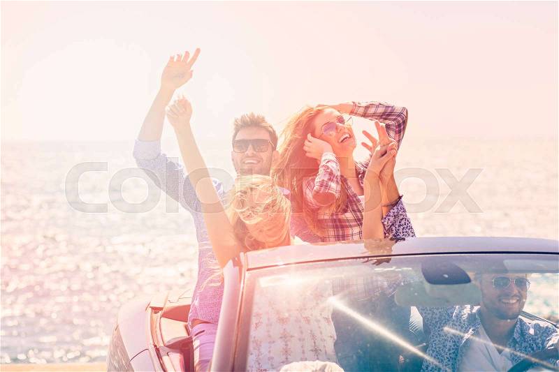 Beautiful party friend girls dancing in a car on the beach happy, stock photo