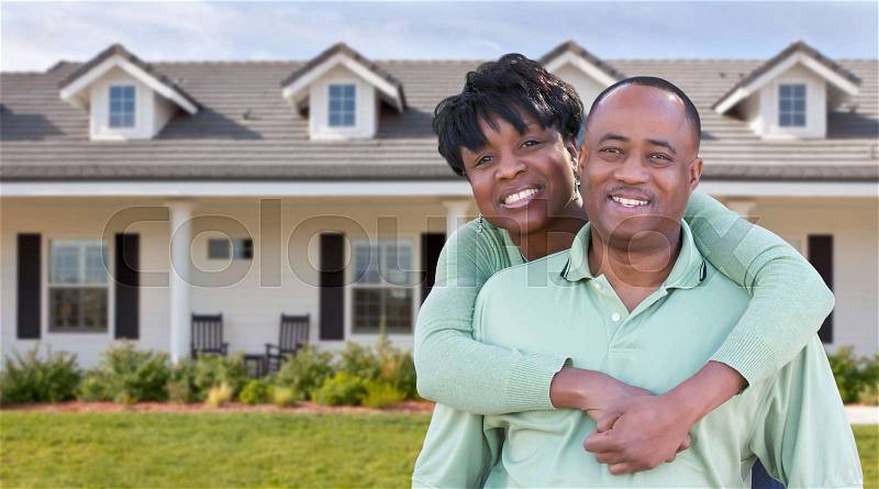 Happy African American Couple In Front of Beautiful House, stock photo