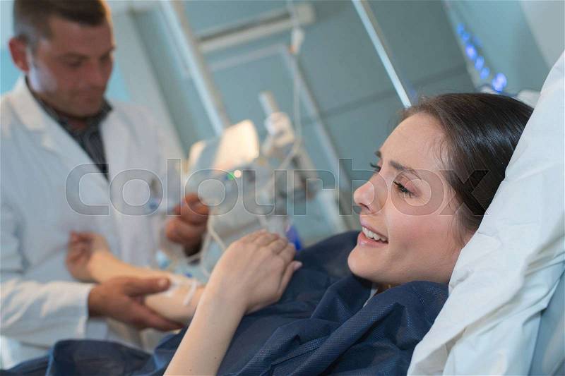 Patient screaming while doctor drawing blood sample in hospital room, stock photo