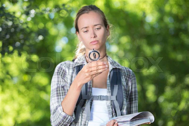 Disoriented hiking girl feeling lost, stock photo
