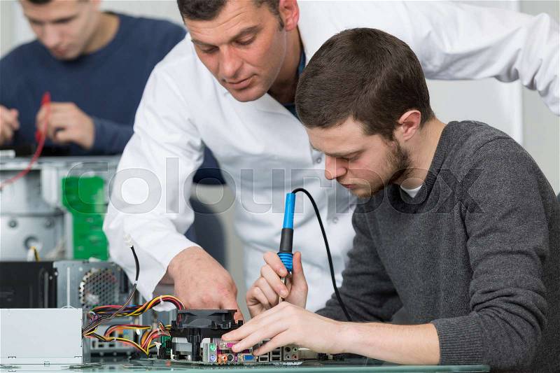 Electronic students and teacher in class, stock photo