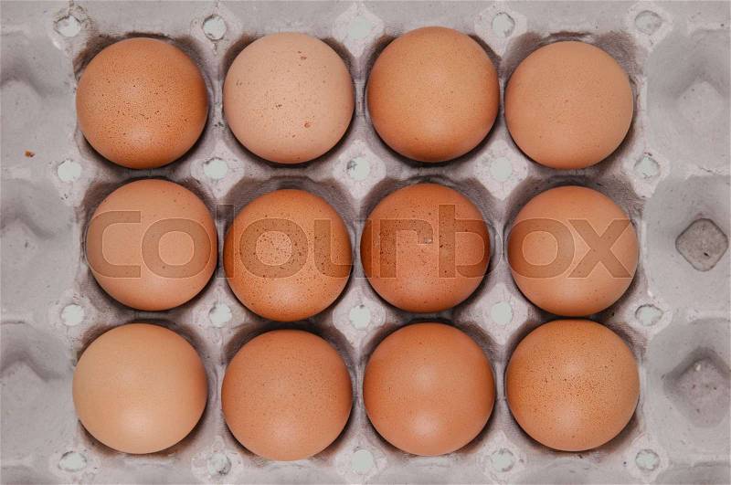 Close-up view of raw chicken eggs in egg box , stock photo