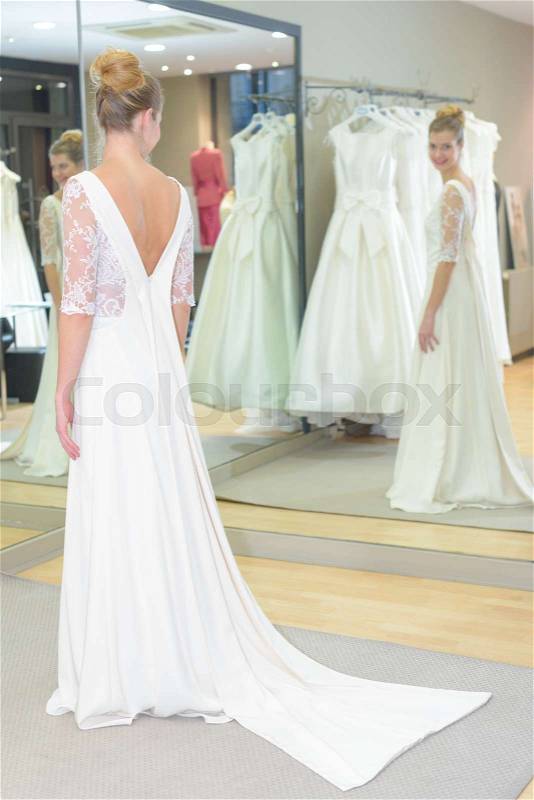A bride-to-be trying on a wedding dress, stock photo