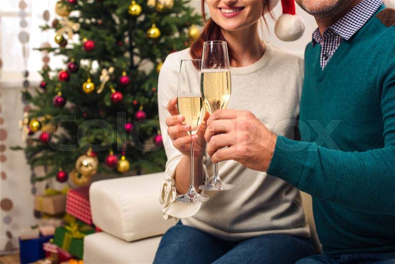 Cropped shot of happy couple drinking champagne at new year, stock photo