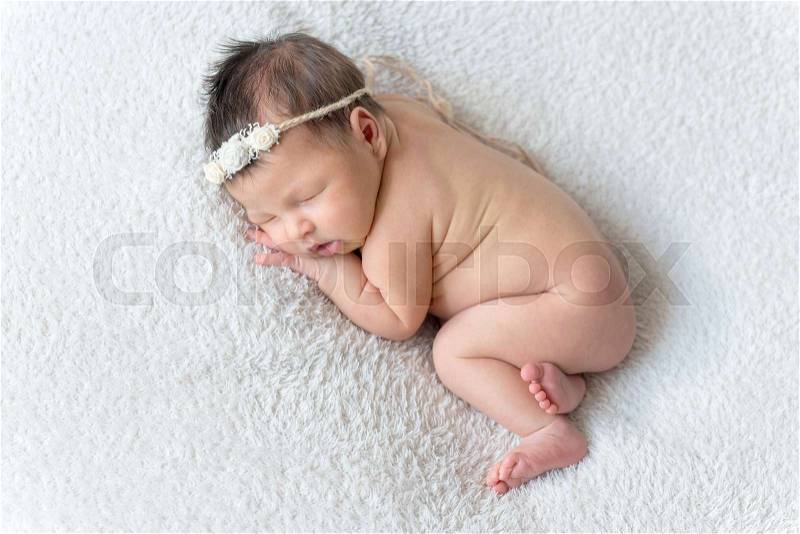 Sweet sleeping newborn baby girl, stock photo