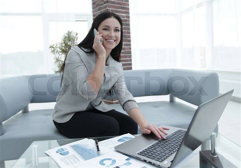 Experienced business woman assistant sitting at the desk. Photo with copy of space, stock photo