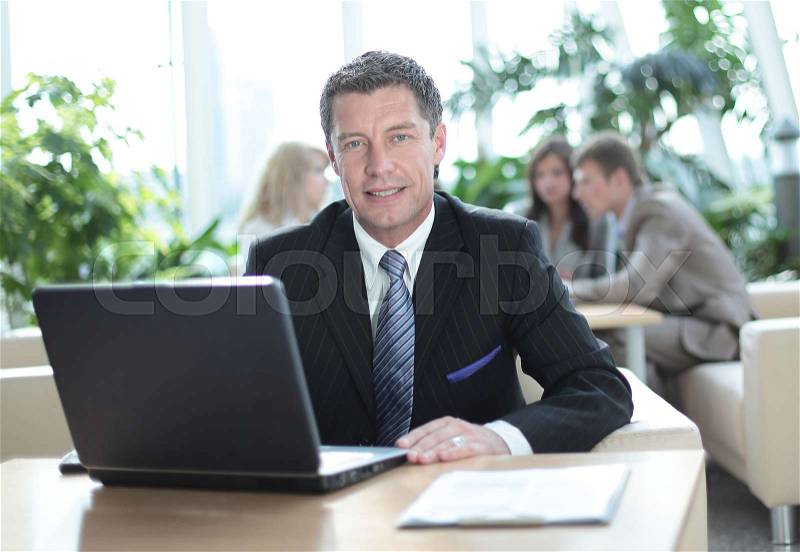 Happy confident middle age businessman looking at camera and smiling, stock photo
