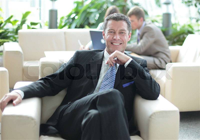 Happy confident middle age businessman looking at camera and smiling, stock photo