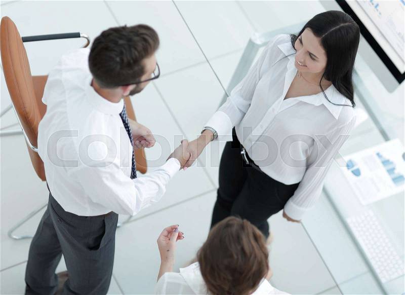Handshake manager and employee near the workplace. photo with copy space, stock photo