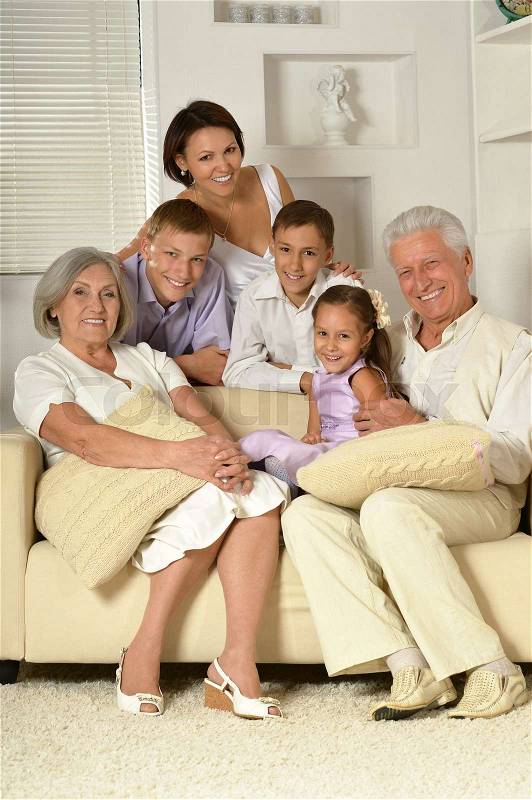 Portrait of big happy family sitting on couch, stock photo