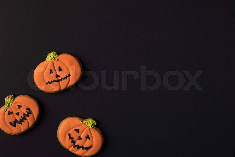 Close-up view of halloween pumpkin cookies isolated on black, stock photo