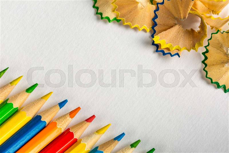 Background with colored pencils and pencils sharpening on paper, stock photo