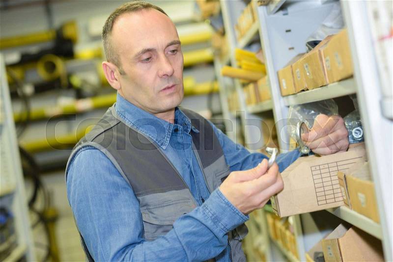 Middle-age man choosing tools in household store, stock photo