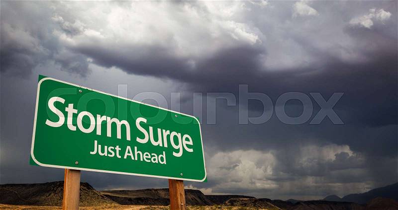Storm Surge Just Ahead Green Road Sign with Dramatic Clouds and Rain, stock photo